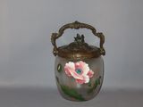 a glass jar with a flower painted on it
