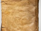 a close up of a piece of old paper on a white surface