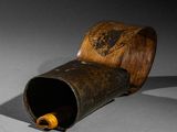 a wooden tube with a wooden handle on a table