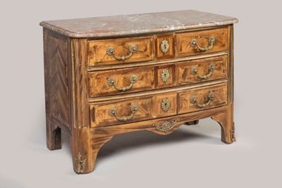 a small wooden chest of drawers with marble top