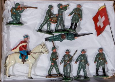 many figurines of soldiers on display in a box