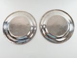 pair of silverplated plates on a white background