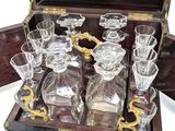 a wooden case with a set of glassware in it