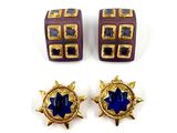 three pieces of jewelry are shown on a white surface