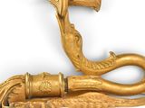 a gold cane with a handle on a white background