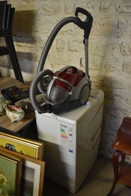 a picture of a room with a washing machine and a painting on the floor