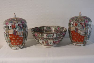 three vases and a bowl sitting on a table