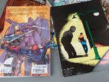 many comic books on the table and one is a spider - man