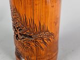 a wooden cup with a pine tree design on it