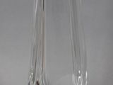 a clear glass vase with a curved design on it