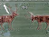 two deers that are standing in the grass