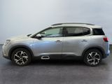 a silver suv parked in a room with a white wall