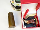 a red box with a watch and other items in it