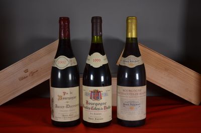 three bottles of wine are sitting on a table next to a wooden box