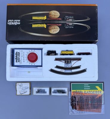 a box with a train set in it sitting on a table