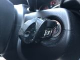 a close up of a steering wheel with a button on it