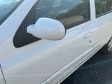 a small white car parked in a parking lot