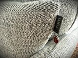 a close up of a couch with a button on it