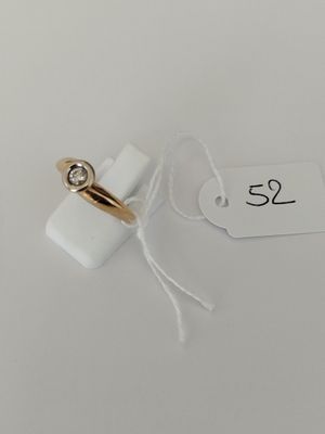 a close up of a tag with a ring attached to it