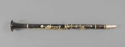 a close up of a clarinet on a gray surface