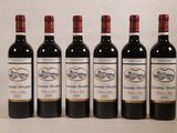six bottles of wine are lined up in a row