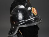 an old fireman ' s helmet on a mannequin head