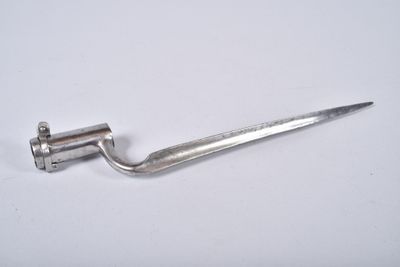 a small metal object that is on a white surface