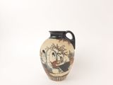 a small vase with a painting on it on a white surface