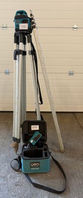 a tripod and a camera on a tripod in front of a garage door