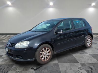 the blue volkswagen golf is parked on a checkered tile floor