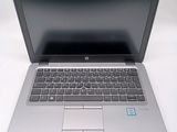 an open laptop computer sitting on top of a white table