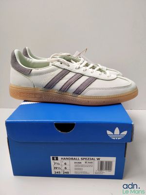 a pair of adidas sneakers on top of a blue box