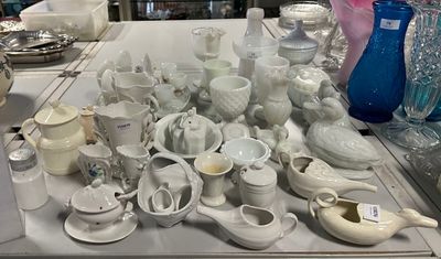 une table sur laquelle sont disposés de nombreux vases blancs et bleus