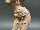 a stone statue of a woman with a dress on her head