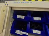 many bins that are on the shelf in the store