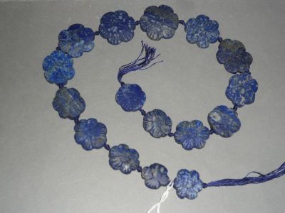 necklace made of blue glass beads with tassels and a tassel