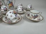 five cups and a saucer on the table