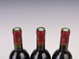 three bottles of wine sitting on top of a table next to each other