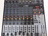 a close up of a sound board on a white table
