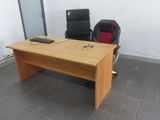 a desk with two chairs and a computer on it