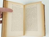 someone is holding a book open and pointing at it