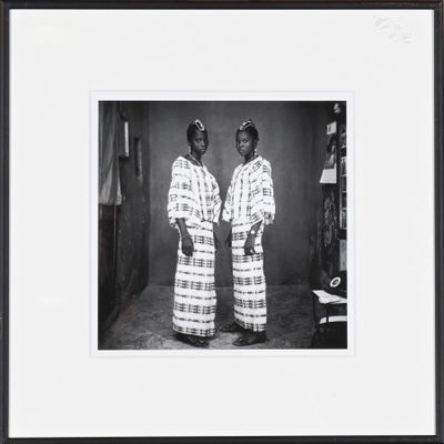 framed black and white photograph of two women in traditional clothing