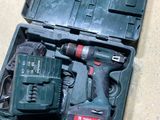 a tool kit in a case on the floor next to a speaker