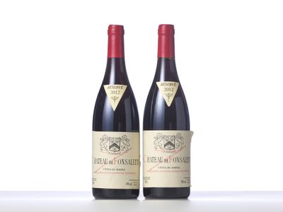 two bottles of red wine sitting next to each other on a table