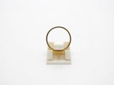an image of a gold ring sitting on top of a white surface