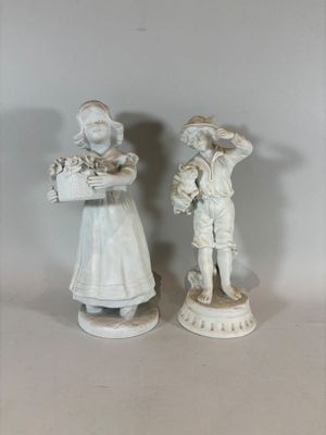 two figurines that are standing next to each other