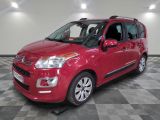 the red citrole is parked in the garage on a checkered floor