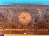 a wooden table with a flower design on the top