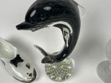 a dolphin figurine and a pair of shoes on a table