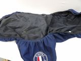a blue jacket with a logo on it sitting on a table